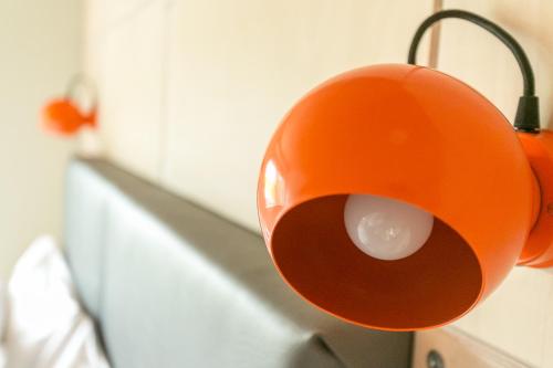an orange object is hanging on a wall at Claron Lodge in West Wittering