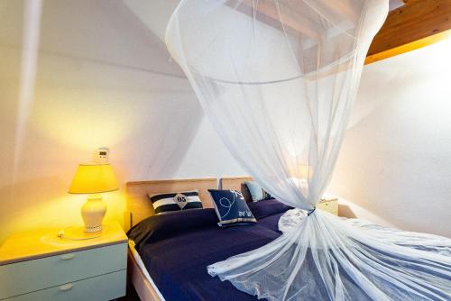 - une chambre avec un lit et une moustiquaire dans l'établissement Casa Zuccale, à Capoliveri