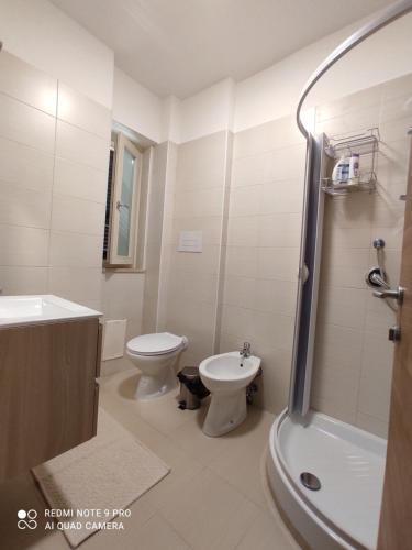 a bathroom with a toilet and a sink and a shower at bbnapl'est in Naples