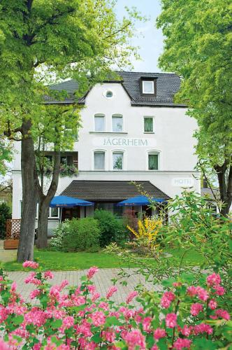 a large white building with flowers in front of it at Jägerheim in Nürnberg