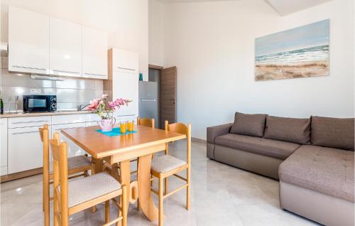 a kitchen and dining room with a table and a couch at Cozy Apartment In Srima in Srima