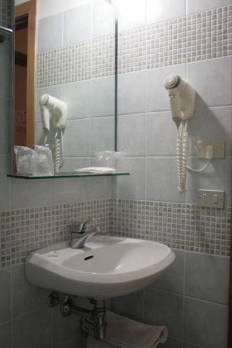 a bathroom with a sink and a mirror at Hotel Risorgimento in Chianciano Terme