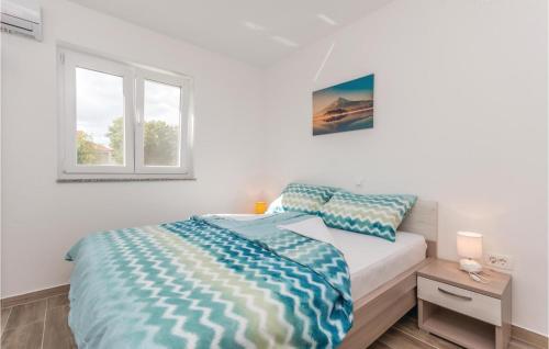 a white bedroom with a bed and a window at Awesome Apartment In Biograd Na Moru With Kitchen in Biograd na Moru