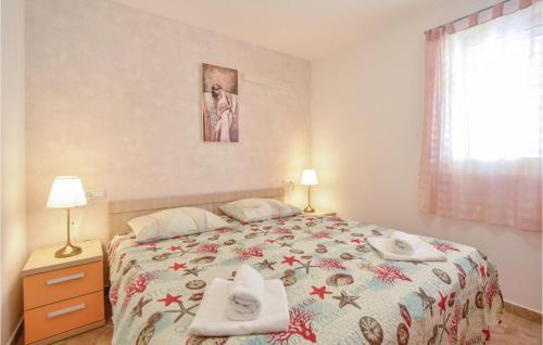 a bedroom with a bed with towels on it at Gorgeous Apartment In Stanici With Kitchen in Čelina