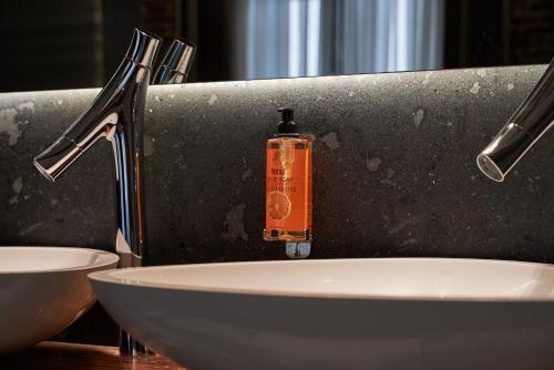 a bathroom sink with a soap bottle on it at Hotel The Public - Special Category in Istanbul