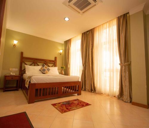 A bed or beds in a room at Panone Hotels - Sakina