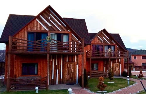a large wooden house with two decks at Four Seasons In Carpathians in Migovo