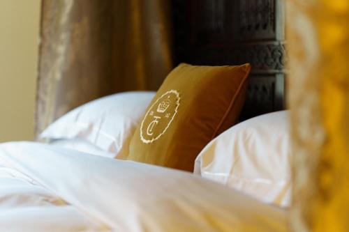 a brown pillow sitting on top of a bed at Thornbury Castle - A Relais & Chateaux Hotel in Thornbury