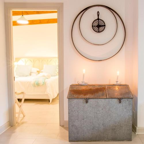 a room with a room with a bed and a table with candles at River Bend Guesthouses in Graaff-Reinet