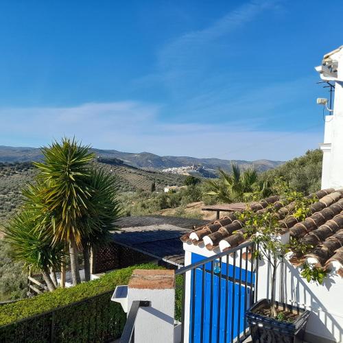 a balcony of a house with a view of the mountains at Casa De Ladera in Iznájar