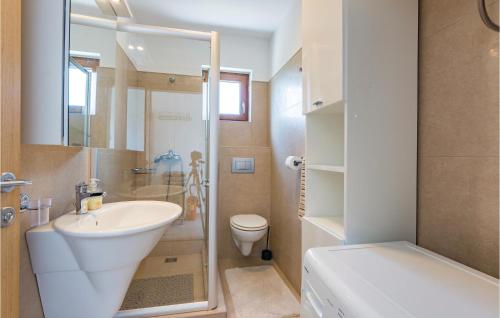 a small bathroom with a sink and a toilet at Beautiful Home In Zminj With Kitchen in Žminj