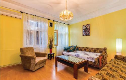 a living room with a couch and a chair at 1 Bedroom Beautiful Apartment In Bakar in Bakar