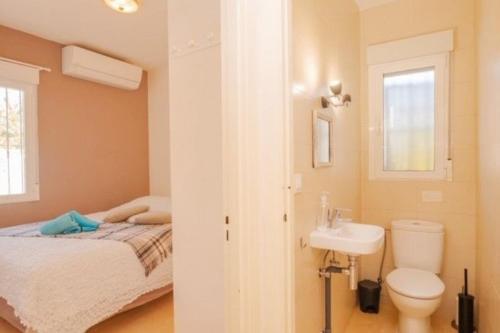 a bathroom with a bed and a toilet and a sink at Casa Kollies in Calpe