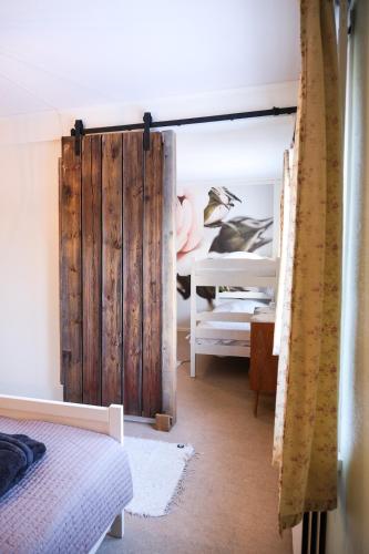 a bedroom with a wooden door and a bunk bed at The Mangevie in Furudal