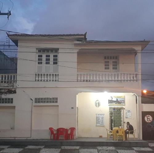 a white building with colorful chairs in front of it at Bela Vista in São Luís