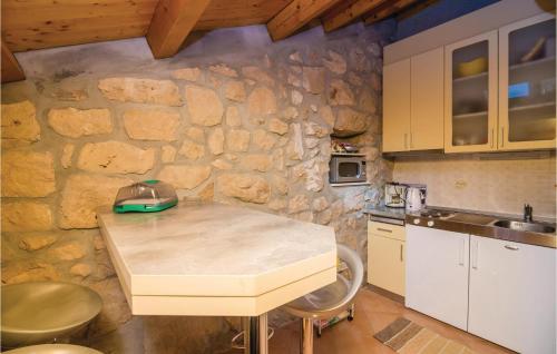 a kitchen with a stone wall and a counter top at 1 Bedroom Cozy Home In Trsteno in Trsteno