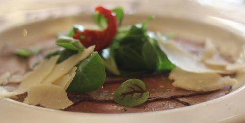 a bowl of soup with meat and vegetables in it at Hôtel Restaurant Lamy in Troisvierges