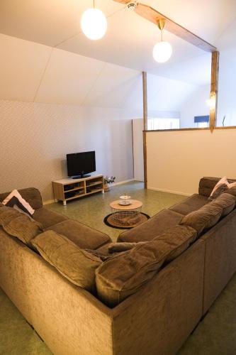 a large couch in a living room with a tv at The Mangevie in Furudal