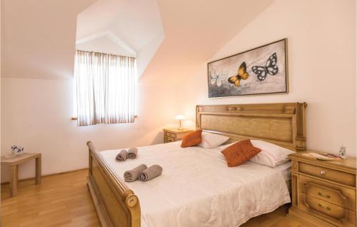 a bedroom with a large bed with two pillows on it at Lovely Apartment In Ugljane With Kitchen in Ugljane