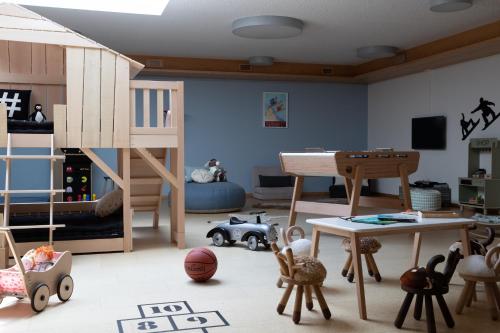 a childs room with a bunk bed and toys at Schweizerhof Zermatt - a Small Luxury Hotel in Zermatt
