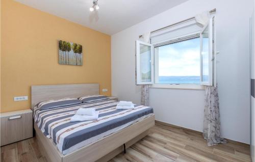 A bed or beds in a room at Beautiful Apartment In Podstrana With House Sea View