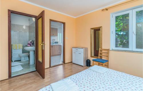 a bedroom with a bed and a bathroom at 1 Bedroom Amazing Apartment In Mali Losinj in Mali Lošinj