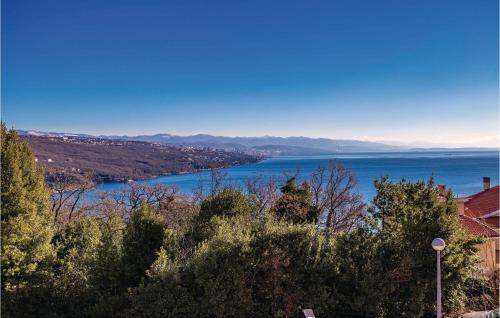 a view of a lake from a hill with trees at 1 Bedroom Awesome Apartment In Volosko in Volosko