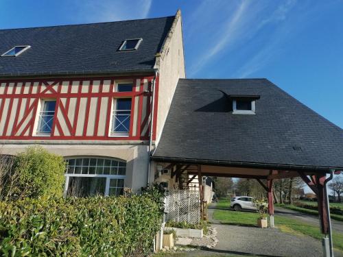 a red and white house with a black roof at Nid de pie Grand duplex lumineux cadre verdoyant calme à 5 mn de la mer près Port en Bessin, Bayeux, Omaha Beach, in Commes