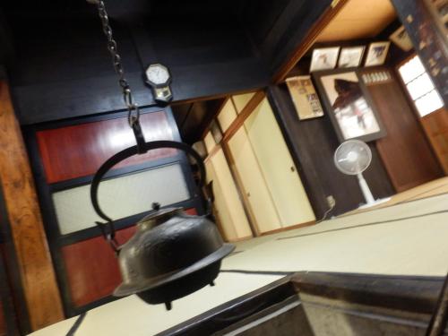 a tea kettle hanging over a stove in a kitchen at Minshuku Yomoshirou in Nanto