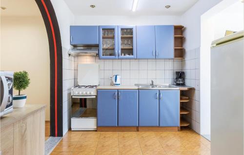 eine Küche mit blauen Schränken und einer Spüle in der Unterkunft 2 Bedroom Stunning Apartment In Pula in Pula