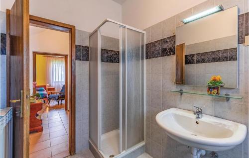 a bathroom with a sink and a shower at Nice Apartment In Porec With Wifi in Poreč