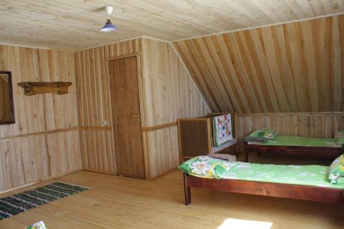 a room with two beds and a table in it at Jaama Puhkemaja in Raigastvere