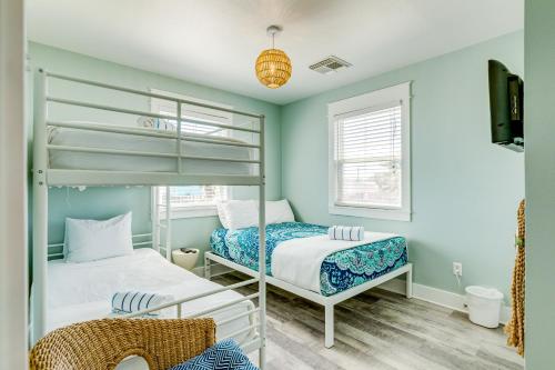 a bedroom with two bunk beds and a television at Sea Salt in Freeport
