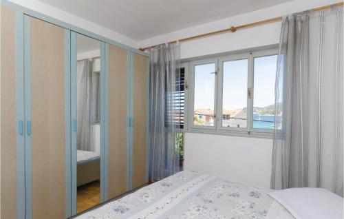 a bedroom with a bed and a large window at Nice Apartment In Vela Luka With Wifi in Vela Luka