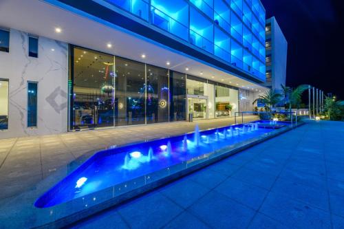 a swimming pool in front of a building at night at Seasons Hotel (Adults Only) in Ayia Napa