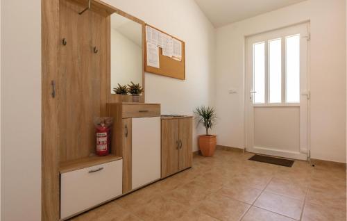 a hallway with a cabinet and a mirror and a door at 3 Bedroom Lovely Home In Sestanovac in Šestanovac