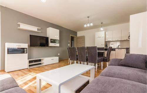 a living room with a couch and a table at Three-Bedroom Apartment In Medulin in Medulin