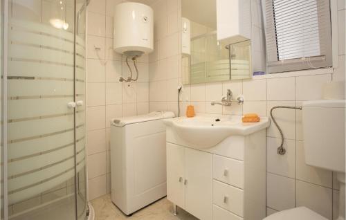 a white bathroom with a sink and a shower at Amazing Apartment In Rijeka With Wifi in Rijeka