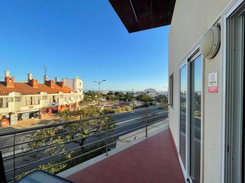 a balcony with a view of a city at T1 ocean view close to Praia da Oura in Albufeira
