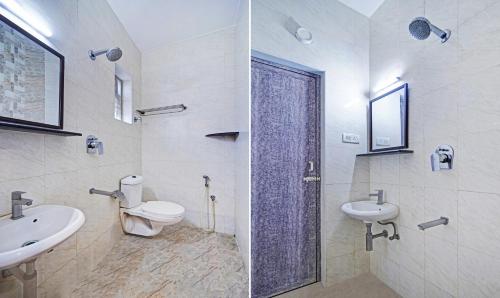 a bathroom with a sink and a toilet and a mirror at Saibala Budget Airport Hotel in Chennai