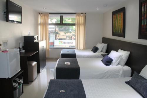 Postel nebo postele na pokoji v ubytování Hotel Acqua Medellín