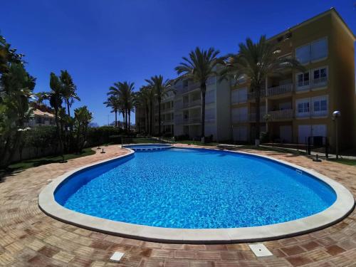 a large swimming pool in front of a building at T1 ocean view close to Praia da Oura in Albufeira