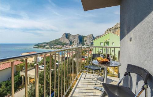 a balcony with a table and chairs and the ocean at Beach Front Home In Omis in Omiš