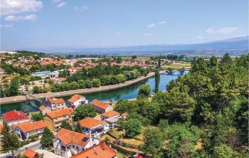 an aerial view of a town with a river at Two-Bedroom Holiday Home In Trilj in Trilj