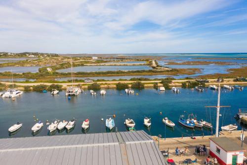 a group of boats are docked in a marina at Apartamento Praia Fuseta 3 - Ria Formosa in Olhão