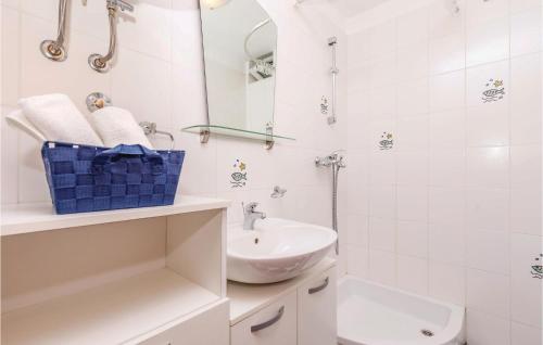 Baño blanco con lavabo y aseo en Nice Apartment In Novi Vinodolski With 2 Bedrooms And Wifi, en Novi Vinodolski