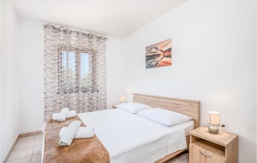 a white bedroom with a bed and a window at Beautiful Apartment In Jurandvor With Kitchen in Jurandvor
