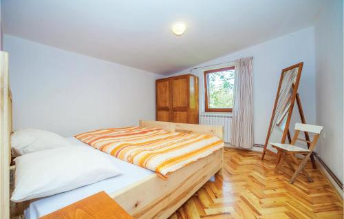 a bedroom with a bed and a chair in it at 7 Bedroom Pet Friendly Home In Crni Kal in Crni Kal