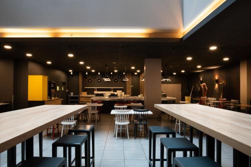 a restaurant with rows of tables and stools at Ibis Praha Old Town in Prague