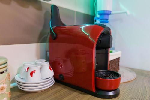 a red toaster sitting on top of a table at Relaxing Coresi Studio in Braşov